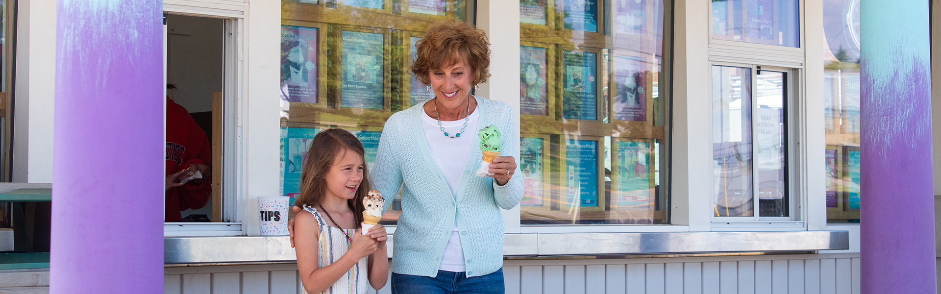 Grandmother and granddaughter eating ice cream.
