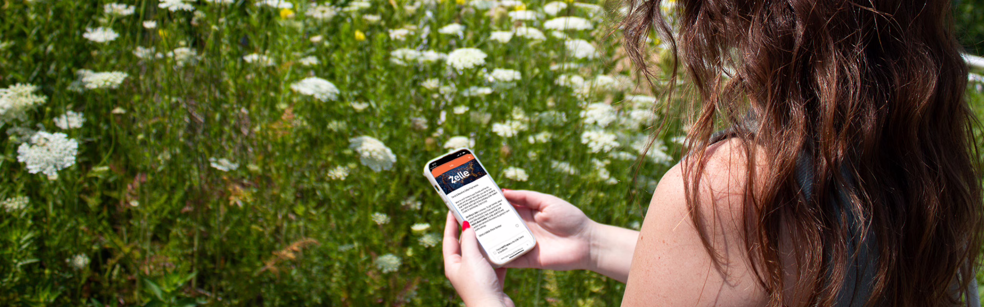 Woman on WMCU Mobile App using Zelle to send money.